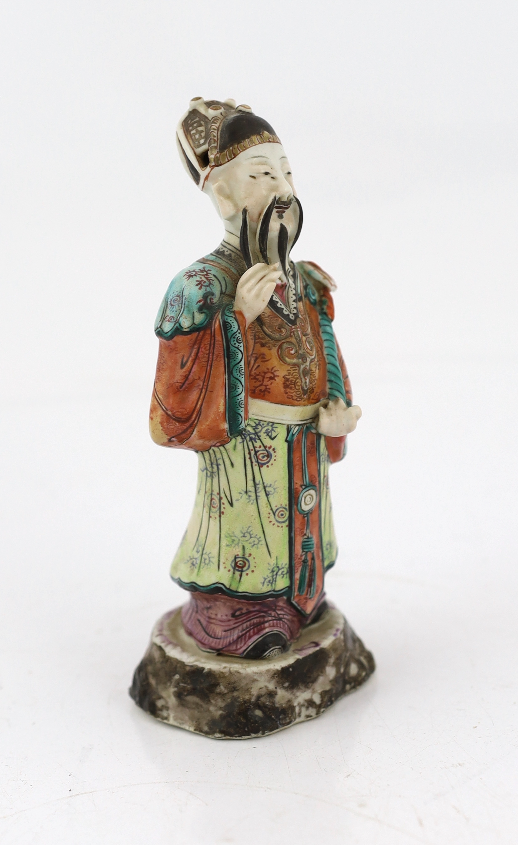 A Chinese enamelled porcelain figure of a court official, Jiaqing period (1796-1820), loss to right index finger